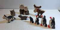 Full group of nine carved animals on tabletop