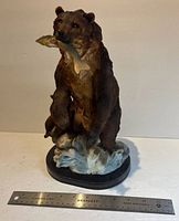 Front view of entire figurine with ruler for scale