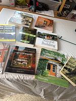 Group shot showing all nine home-building books laid out on table