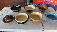 All seven ceramic bowls arranged on table