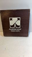 Front of brown Clover Leaf Table Mats box