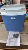 Front view of blue Ezetil cooler with lid closed and manual visible