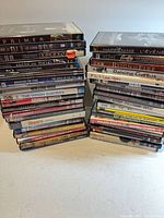 Two tall stacks of movie discs showing quantity and variety