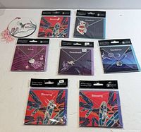 Overview of seven sealed greeting cards with charms plus additional round hummingbird card