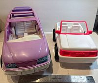 Both Barbie vehicles side by side with ruler for scale