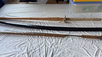 Overview of three swords laid out on table
