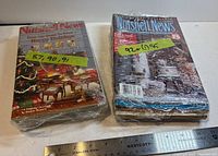 Two shrink-wrapped stacks of Nutshell News magazines with years labeled