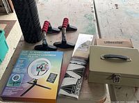 Full lot overview showing foam roller, push-up handles, ring light box, wall decal, UBeesize tripod box and cash box closed