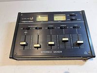 Front angled view of mixer showing entire faceplate, sliders and meters