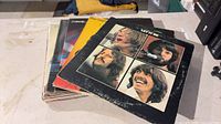 Stack of LPs with Beatles Let It Be cover on top