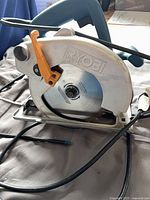 Overall view of Ryobi circular saw showing blade guard, handle and power cord