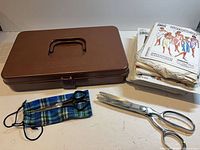 Overview of lot: sewing box, stack of patterns, both scissors, fabric pouch