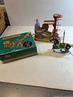 Overview of three tin toys and basketball player box