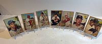 All seven sleeved 1962 Topps rookie cards displayed on stands