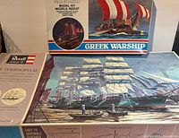 Closed boxes of both model kits showing artwork and branding