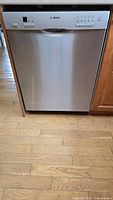 Front view of closed stainless steel Bosch dishwasher