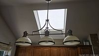 Full view of brushed nickel 3-light pendant installed, showing overall design and proportion