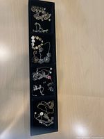 Overview of four-section tray holding mixed jewelry pieces