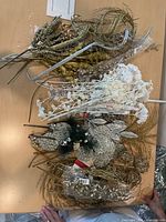 Overview of assorted glitter picks, white branches and bird ornaments on table
