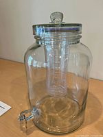 Full view of glass dispenser showing body, spigot, and ice core