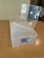 Outer box with lid open showing six internal cases