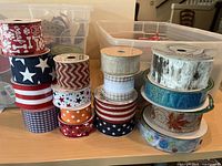 Stacks of ribbon rolls showing various colors, patterns and materials