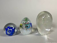Front view of all three paperweights