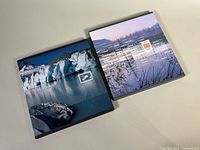 Front view of both slipcased books showing cover images