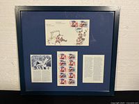 Full view of framed stamp display with mat and glass