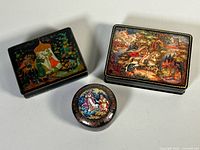 All three boxes front view showing artwork and scale