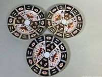 All three Royal Crown Derby salad plates front view