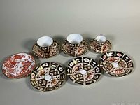 Full set of cups, saucers and side plate laid out