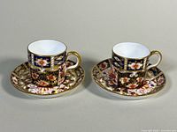 Two demitasse cups on saucers, full view