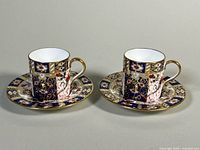 Two demitasse cup and saucer sets side by side