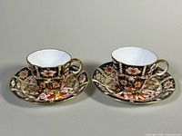 Two Royal Crown Derby Imari teacups and saucers front view