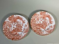 Both Royal Crown Derby Red Aves plates top view