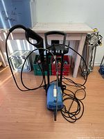 Full view of pressure washer with hose and wands