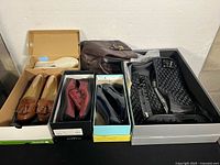 Overview of five pairs of shoes and boots in boxes