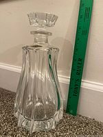 Front view of Bohemia Crystal decanter beside ruler showing height