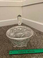 Side view of bohemian cut crystal bowl with lid and ruler for scale