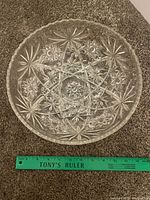 Top view of clear hobstar glass bowl with ruler showing ~10 in. diameter