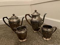 Full set showing both teapots, sugar, creamer
