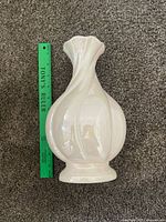 Full view of vase lying horizontally beside ruler