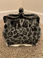 Front view showing black and white swirl pattern and applied black handle