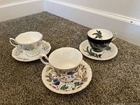 Overall view of three teacup and saucer sets