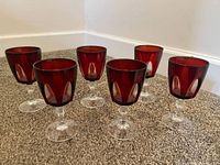 Six ruby red goblets side view