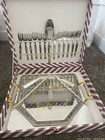 Open presentation case showing tray, dessert forks, and cake server
