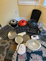 Group shot of all kitchen appliances and bakeware on floor