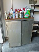 Front view of closed metal cabinet with wood top