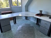 Overall view of L-shaped desk, pedestals, plastic floor mat